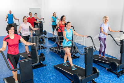 Fitness class walking on treadmill running belt