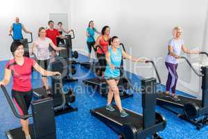 Fitness class walking on treadmill running belt