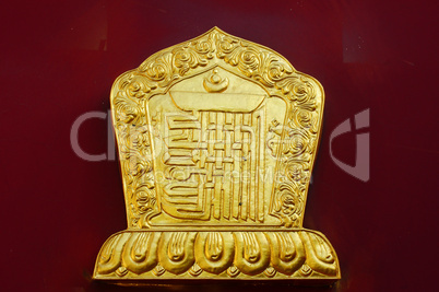 Golden decoration on a lamasery's red wall