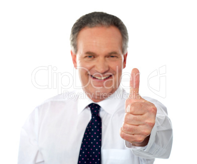 Matured businessman gesturing thumbs-up