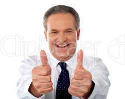Happy businessman gesturing double thumbs-up