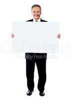 Businessman holding a blank billboard