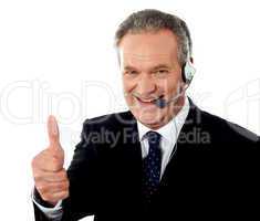 Call centre executive smiling with thumbs-up