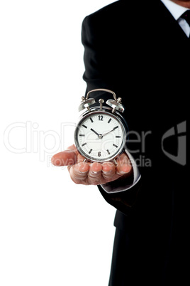 Cropped image of a man with alarm clock on his palm