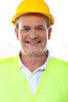 Smiling senior builder wearing hardhat