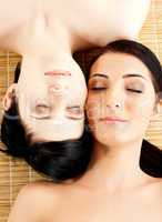 Massage of two beautiful females in spa salon