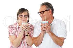 Happy matured couple holding cofee mug