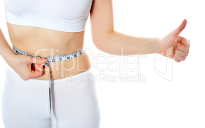 Closeup of tape measure around woman waist