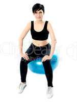 Fitness woman isolated sitting on pilate ball