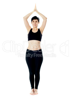 Full-length view of fit woman doing yoga