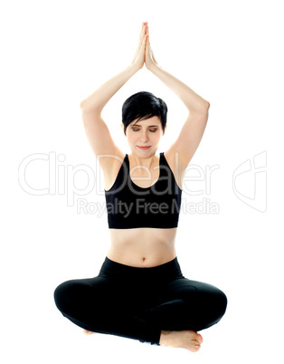 Beautiful blonde girl meditating in black