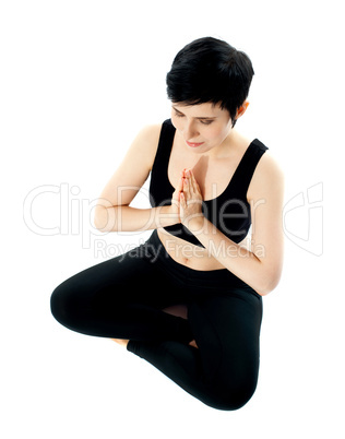 Young woman practicing yoga in the lotus position