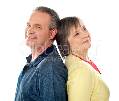 Closeup shot of aged couple, back to back