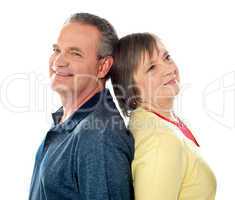 Closeup shot of aged couple, back to back