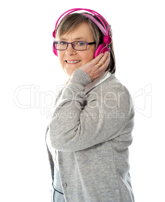 Aged woman enjoying music