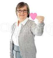 Female holding a pink paper heart