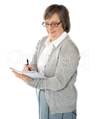 Portrait of a businesswoman writing notes