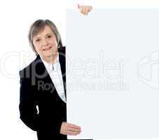 Female executive holding blank whiteboard