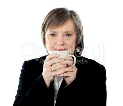 Old woman holding coffee mug