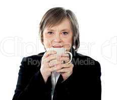 Old woman holding coffee mug