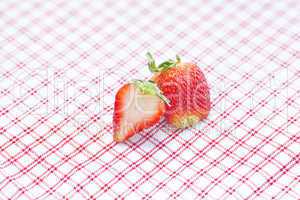 strawberries lying on plaid fabric