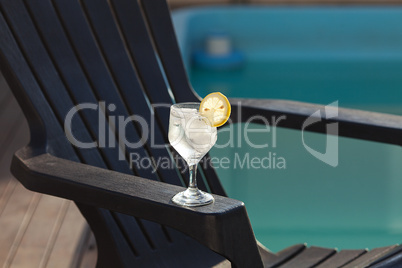 Swimming pool, lounge, a wine glass with ice, lemon and strawber