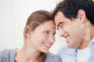 Couple smiling while touching forehead
