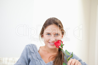 Woman holding a rose while smiling