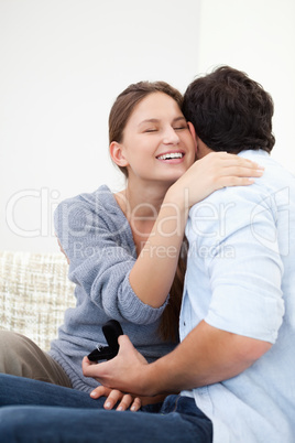 Couple embracing eachother while holding a jewel case