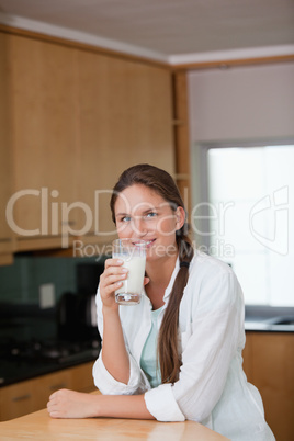 Woman drinking a glass of milk