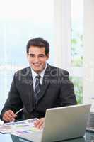 Man working on graph while smiling