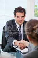Businessman shaking hands with a Businesswoman