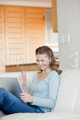 Woman discussing with someone through a laptop