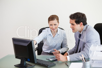 Colleagues working together on a computer