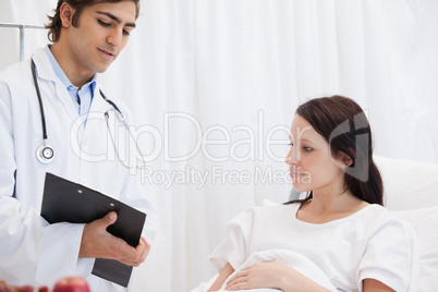 Doctor showing sheets to a patient