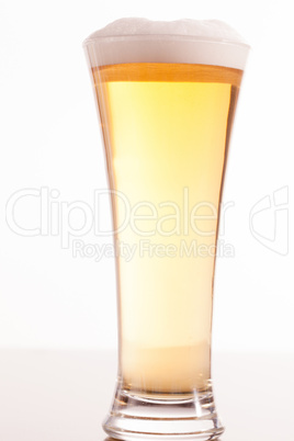 Full glass filled with beer and foam