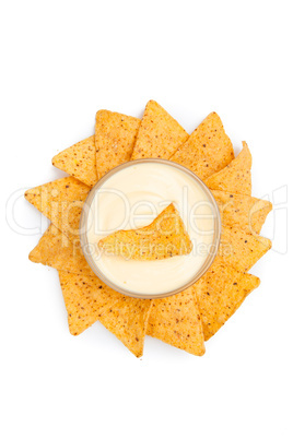 Bowl of white dip surrounded by nachos