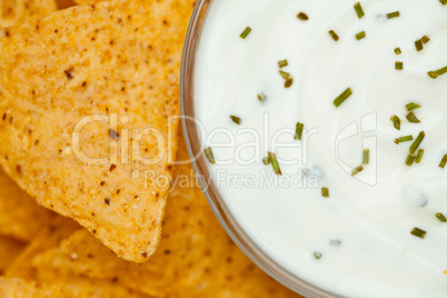 Close up of a bowl of white dip  beside nachos