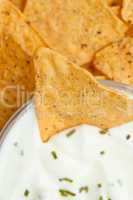 Close up of a bowl of white dip with herbs