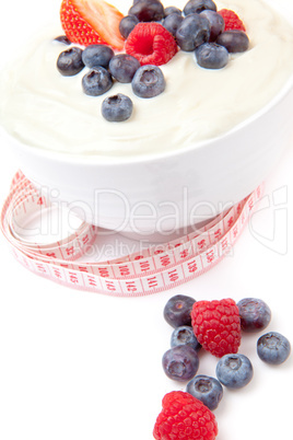 Different berries cream with a tape measure