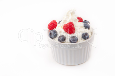 Jar of berries and whipped cream