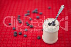 Pot of yoghurt with blueberries