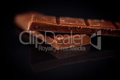 Two blurred bar of dark chocolate