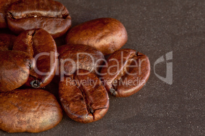 Coffee seeds laid out together on a black table