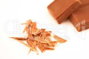 Blurred chocolate pieces and chocolate shaving