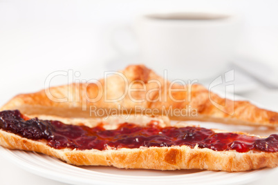 Croissant placed near a coffee cup