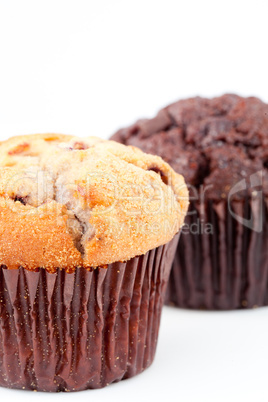 Close up of a fresh baked muffin and a blurred chocolate muffin