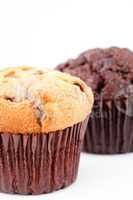 Close up of a fresh baked muffin and a blurred chocolate muffin