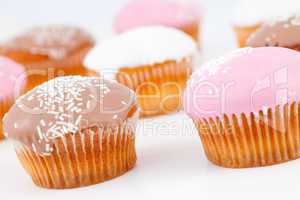 Muffins with icing sugar placed together