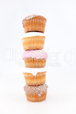 Five muffins with icing sugar piled up